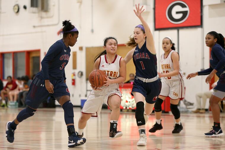 Cardinal O'Hara's Sydni Scott (left) and Kerry Patterson (right) defend Central's Alexis Lin.