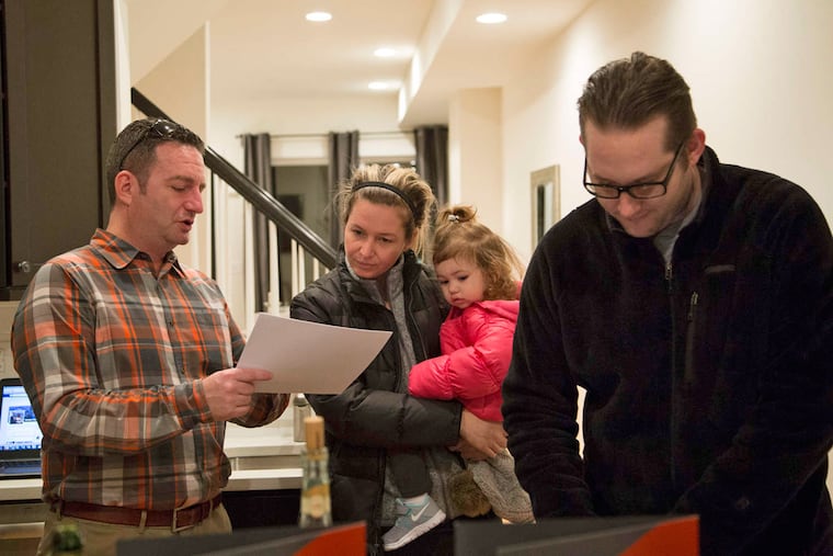 Robert Dischert talks to Stephanie Minix about cost analysis as her daughter, Kennedy, and husband, Charles, listen in.