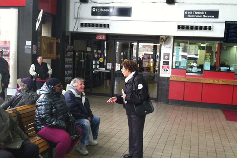 Vernoique Hakim (center), the new executive director of NJ Transit, right, talks with bus passengers waiting in the Walter Rand Transportation Center in Camden, NJ. (PAUL NUSSBAUM/STAFF)