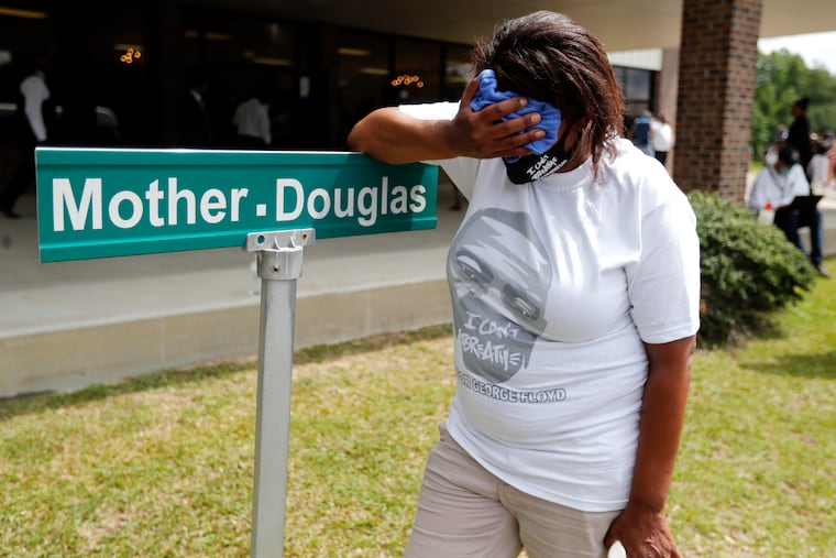 A mourner is overcome with grief after viewing the body of George Floyd during his memorial service, Saturday, June 6, 2020, in Raeford, N.C.