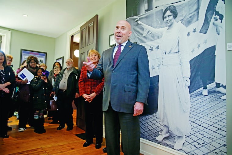 With a large photo of Alice Paul, right, looking over his shoulder, New Jersey Congressman Tom MacArthur, center, announced he was reintroducing a bill to award Paul a Congressional Gold Medal, on the 131 anniversary of Paul's birthday on Monday.
