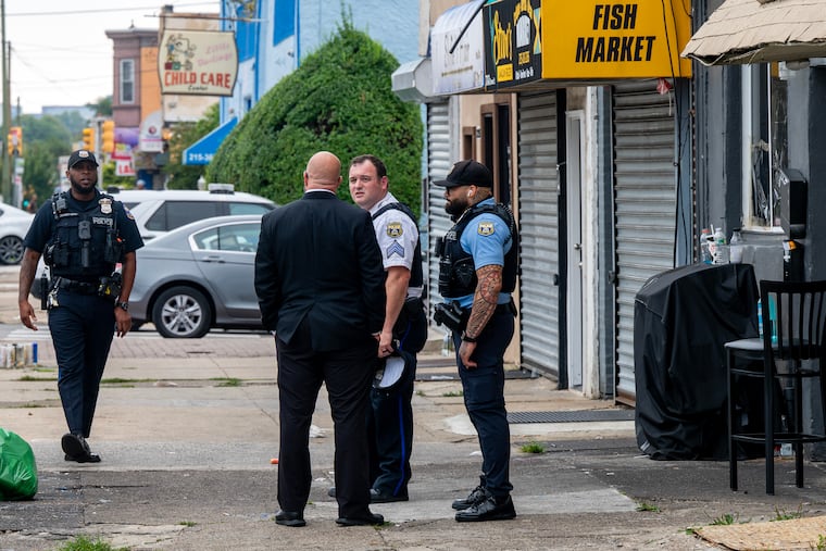 Detectives and police officers remain on the scene Sunday morning, Aug. 16, 2026 at Elmwood Avenue and South 73rd Street, where earlier an off-duty Philadelphia police officer died after he was shot at an after-hours lounge near the intersection.