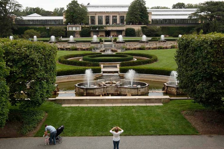A visitor photographs the Fountain Garden looking towards the conservatory. Longwood Gardens in Kennett Square is about to embark on the most expensive project ever - the three-year, $90-million restoration of its iconic Main Fountain Garden. September 16, 2014. ( MICHAEL S. WIRTZ / Staff Photographer )