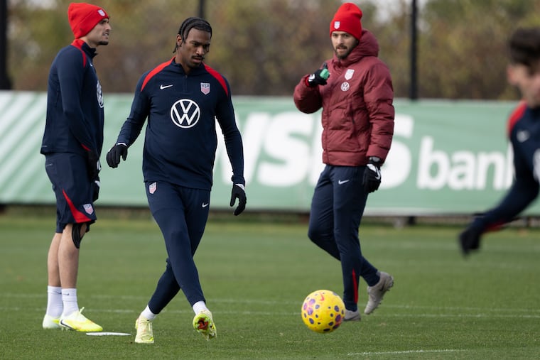 Haji Wright (second from left) at work Tuesday during the U.S. team's practice in windy Chester.