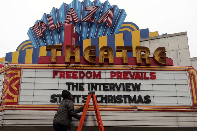 The Plaza Theatre in Atlanta is among those showing "The Interview." Manager Brandon Delaney was adjusting the marquee Tuesday.