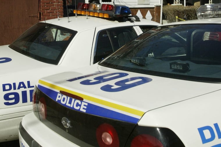 Two Philadelphia police cars parked next to each other.