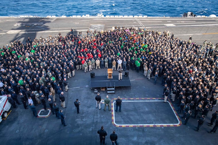 In this Dec. 15, 2019, photo, U.S. Navy Capt. Brett Crozier, commanding officer of the aircraft carrier USS Theodore Roosevelt, addressed the crew during an all hands call on the ship's flight deck while conducting routine training in the Eastern Pacific Ocean.