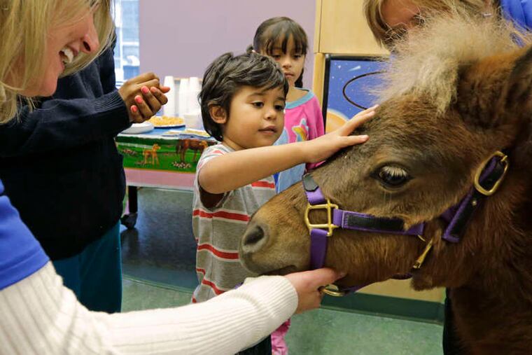Patients Nathaniel Lopez (left) and Araceli Morales pet Lunar.