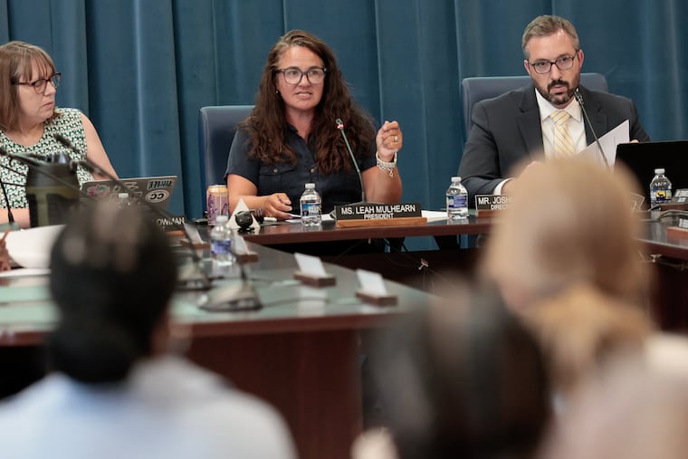 Cheltenham school board president Leah Mulhearn (center) speaks during a board meeting Tuesday, Aug. 11, 2026, in Elkins Park.
