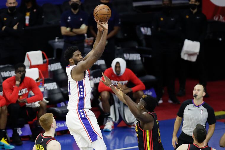 Sixers center Joel Embiid shoots over Atlanta Hawks center Clint Capela in Game 7 of the Eastern Conference semifinals.
