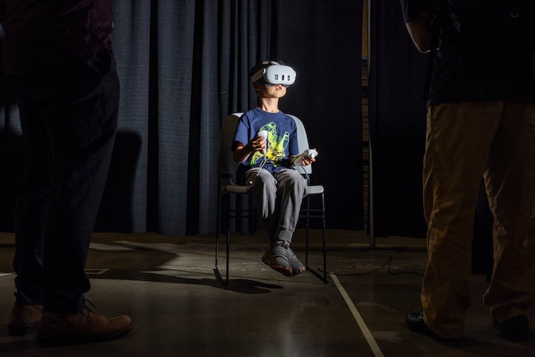 Alexander Yang, 6, of Arlington, Va., plays a virtual reality simulated game during the 2026 International Congress of Mathematicians at the Convention Center on Saturday, July 25, 2026, in Philadelphia.
