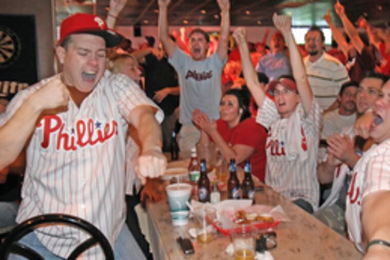 Wild with glee, Phillies fans celebrate the pennant at Reale's Sports Bar at Cottman and Frankford avenues.