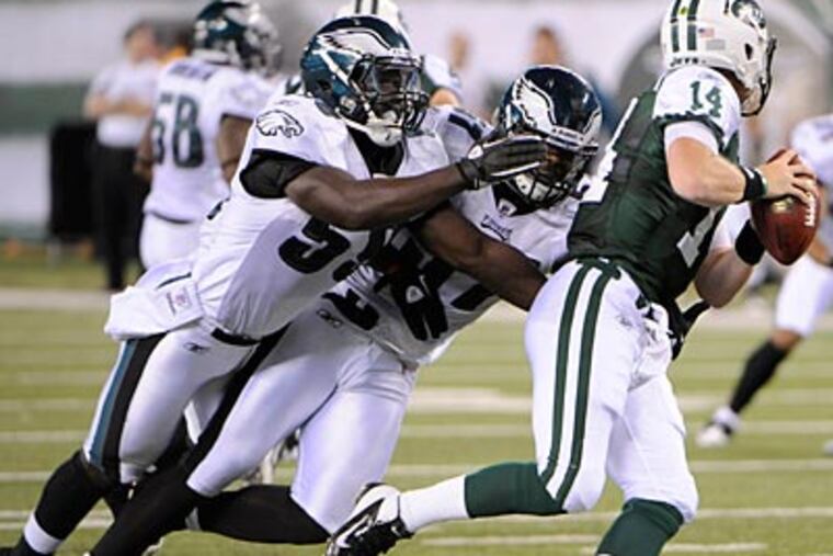 Brian Rolle (left) will compete at weakside linebacker this coming season. (Bill Kostroun/AP file photo)