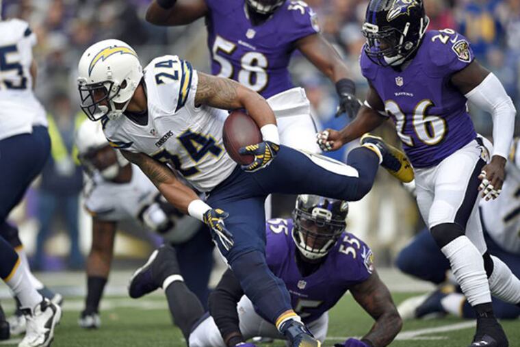 Ryan Mathews, center, rushes past Baltimore Ravens defenders. (AP Photo/Nick Wass)