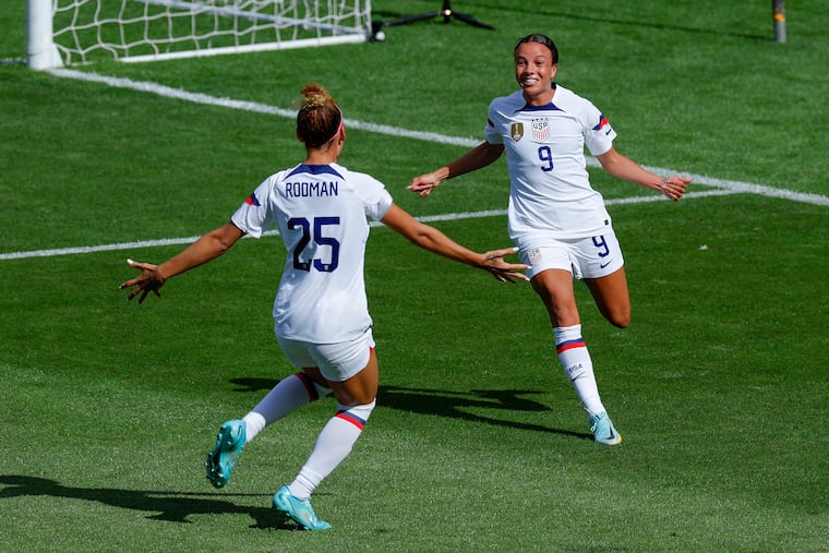 Mallory Swanson (right) celebrates with Trinty Rodman (left) after they combined for one of Swanson's goals.