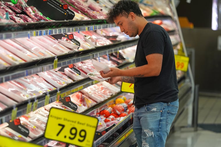 A shopper looks at packages of meat at a grocery store in Dallas, April 15, 2026. Economists expect things could get rockier for consumer spending in the coming months, especially if energy prices remain elevated.