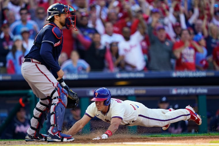 Philadelphia Phillies catcher J.T. Realmuto (10) slides into home safely for his historic inside-the-park home run on Saturday.