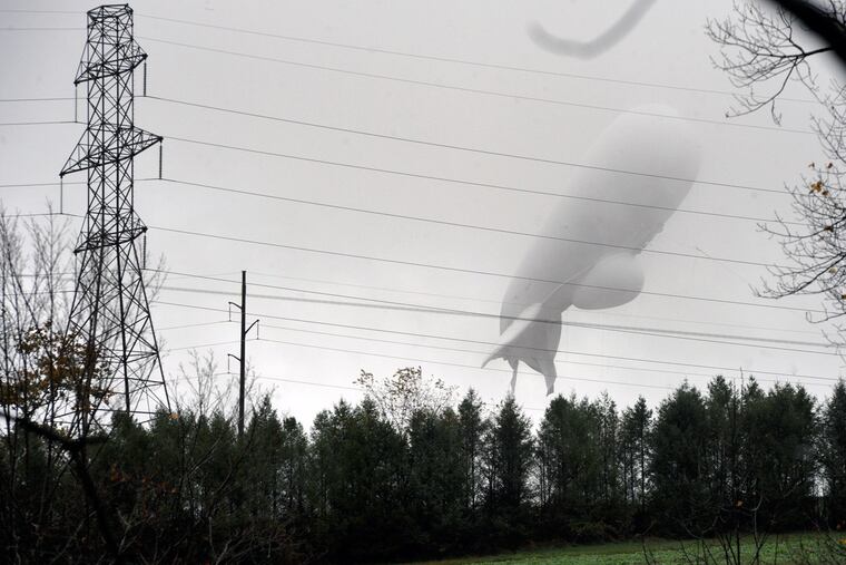 An unmanned Army surveillance blimp floats through the air while dragging a tether line just south of Millville, Pa., Wednesday, Oct. 28, 2015.