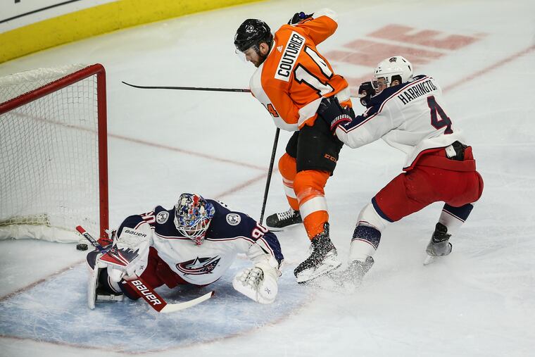 Flyers center Sean Couturier getting the puck past Columbus goalie Elvis Merzlikins during a Feb. 18 game. The Flyers won, 5-1, to start a six-game winning streak.