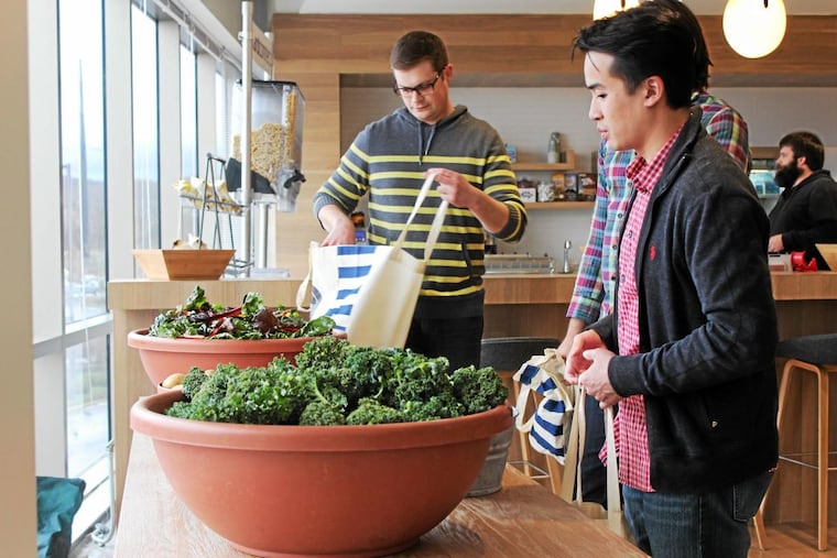 At CardConnect in King of Prussia, employee James Le (right) and others help themselves to free, local fresh produce every other week during the growing season. “It’s like Black Friday in here when the boxes show up,” says Jen Ireland, vice president of human resources.