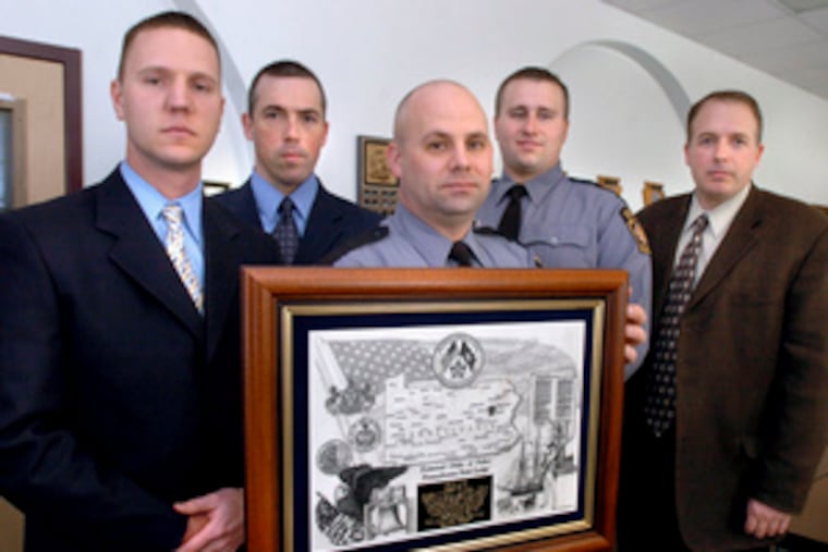 Sgt. Douglas Burig (second from left) with other troopers honored in February with a Heroism Award. The first officers at a scene need better equipment, Burig said.