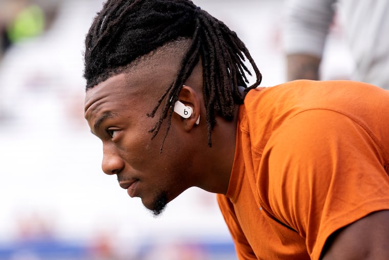 Texas running back Bijan Robinson stretches before an NCAA college football game against Oklahoma at the Cotton Bowl, Saturday, Oct. 8, 2022, in Dallas. (AP Photo/Jeffrey McWhorter)
