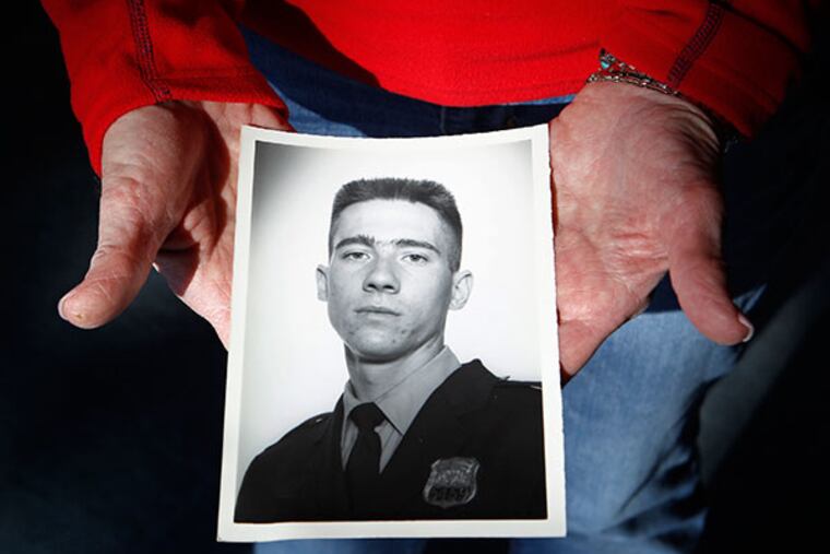 Nancy Boyle, mother of slain Police Officer Danny Boyle, holds a Police Academy graduation photograph of Danny Boyle on Jan. 24, 2014. Earlier this month, a judge vacated the death sentence of the man who killed Danny. ( MICHAEL BRYANT / Staff Photographer )