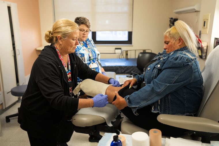 Heidi Hunt (left), a certified registered nurse, treats Kelly Wyatt for a serious xylazine wound at Einstein Hospital in Philadelphia in November. Under siege and belittled by the Trump administration, nurses are speaking out.