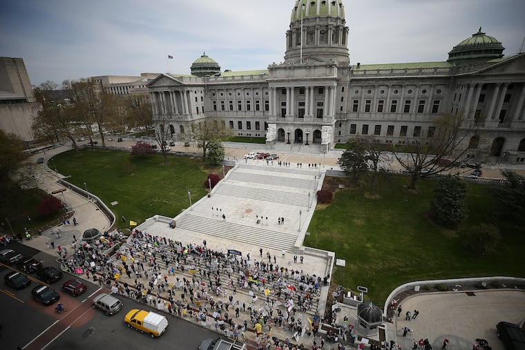 Protesters gather outside the state Capitol in Harrisburg on Monday, calling for Gov. Wolf to reopen Pennsylvania's economy.