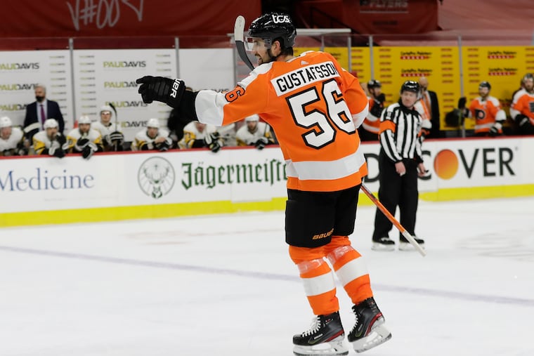 Flyers defenseman Erik Gustafsson points to his teammate after his power-play shot deflected off Nolan Patrick to give the Flyers a 2-1 first-period lead over Pittsburgh on Wednesday.