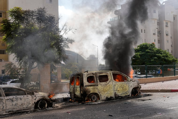 Cars on fire after they were hit by rockets from the Gaza Strip in Ashkelon, Israel, on Saturday, Oct. 7, 2023.