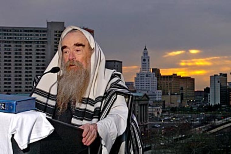 Abraham Shemtov, chief rabbi of the local Lubavitchers conducts part of the ceremony Birkat Hachamah, or Blessing of the Sun, on the roof of the Franklin Institute. ( Clem Murray / Staff Photographer )