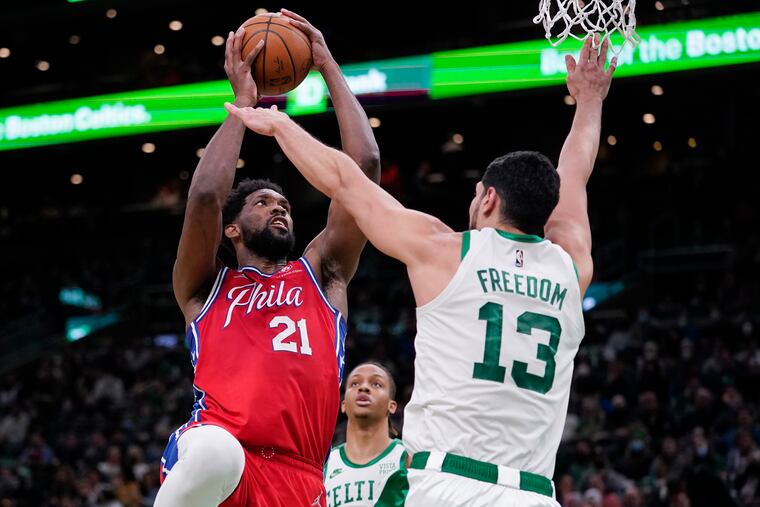 Joel Embiid shooting over Boston Celtics center Enes Freedom during the second half Monday.
