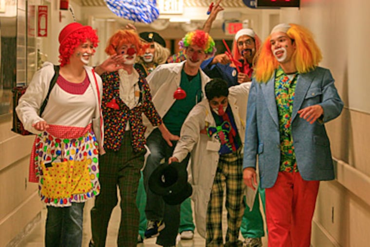 Hoping to heal with humor, a group of medical students at Jefferson University Hospital don wigs and clown makeup before visiting patients who need a boost. (Akira Suwa / Staff)