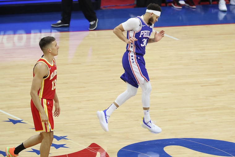 Seth Curry, right, of the SIxers dances up the court after a 3-pointer against the Hawks during the 1st half of game 2 of their NBA playoff series at the Wells Fargo Center on June 8, 2021.