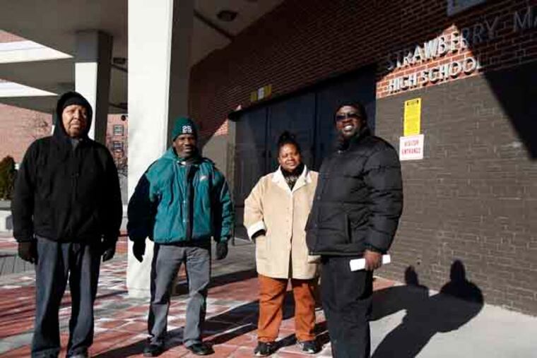 (left to right) James Royal, Tyrone Williams, Tanya Parker, and Donnell Tillery stand outside Strawberry Mansion High School in Philadelphia on January 2, 2013. ( DAVID MAIALETTI / Staff Photographer )