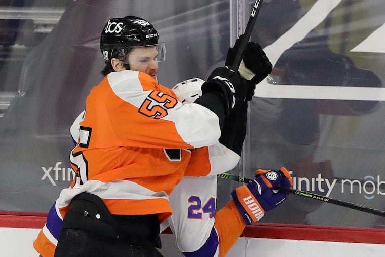 Flyers left winger Samuel Morin checks New York Islanders defenseman Scott Mayfield in a game last Saturday. He played left wing and defense in the Phantoms' exhibition game Thursday.