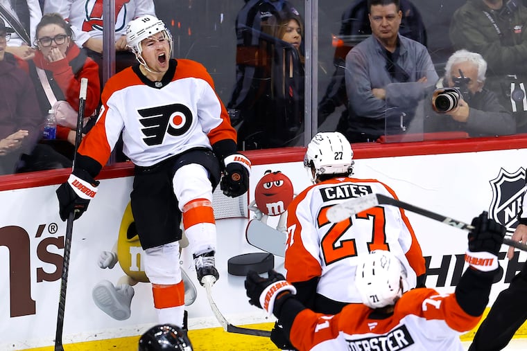 Flyers right wing Bobby Brink (10) celebrates with Noah Cates (27) and Tyson Foerster (71) after scoring a goal against the New Jersey Devils on Saturday.