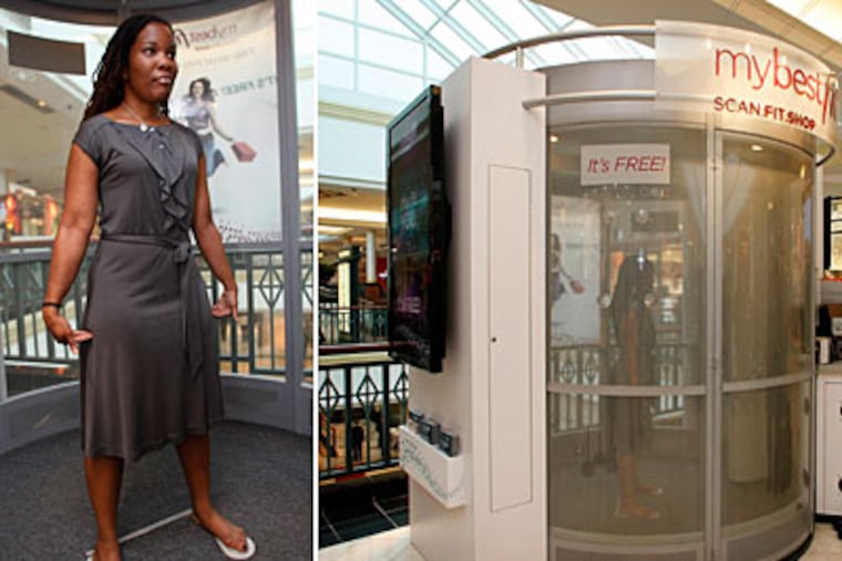 The writer, left, is measured in the Mybestfit scanner. (Michael S. Wirtz / Staff Photographer)