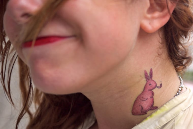 Marc Johns' pipe-smoking rabbit takes up temporary residence on a wearer's neck. Depending on the style, placement, and how the light hits it, a temporary tattoo is easy to mistake for real - at least before it starts wearing off. (Photo courtesy of Tattly)