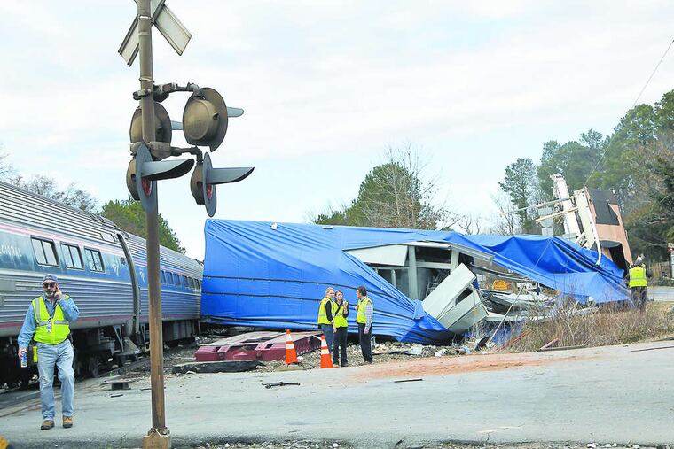 The driver of an oversize load that was struck by an Amtrak train is a convicted felon who nonetheless has a valid commercial driver's license.