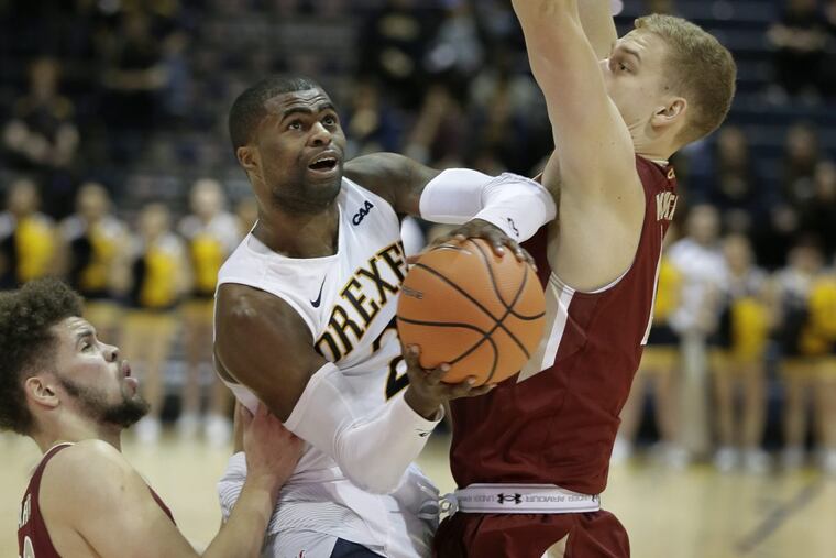 Drexel’s Tramaine Isabell splits Elon defenders on Thursday. Isabell’s clutch free throws carried the Dragons on Saturday.