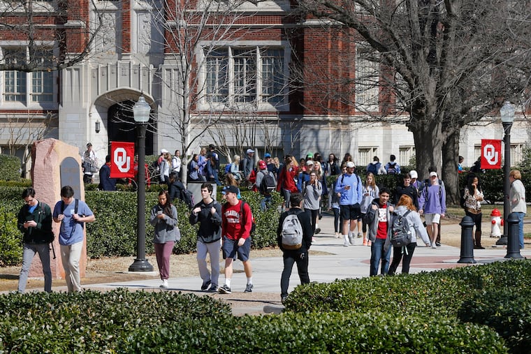 People walk on the Oval at the University of Oklahoma in Norman, Okla., on March 10, 2015.