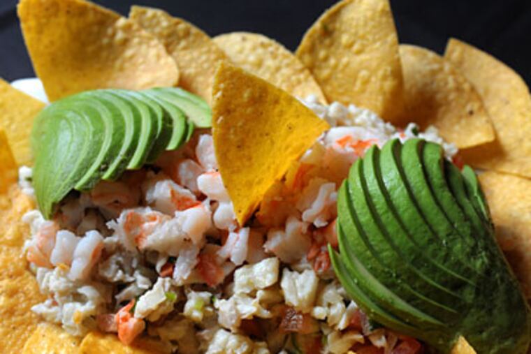 The shrimp and snapper ceviche is pristine, chilled in a citrusy brew tinged with serrano heat, then ringed with warm chips and creamy green fans of avocado. (CLEM MURRAY / Staff Photographer)