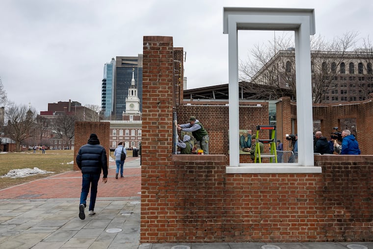 Workers re-hang panels at the President’s House in Independence National Historical Park in February.