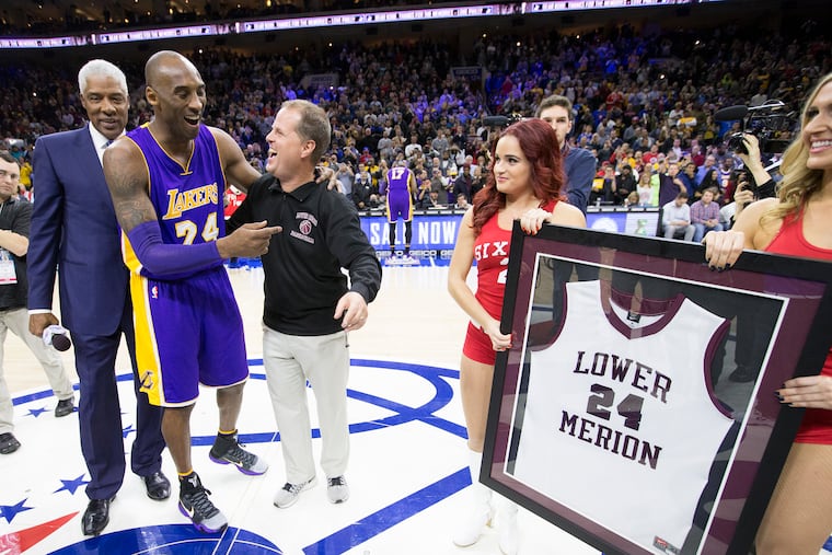 Julius Erving (left) and Lower Merion High's Gregg Downer presented Kobe Bryant with a framed Lower Merion jersey at Bryant's last game in Philadelphia, on Dec. 1, 2015.
