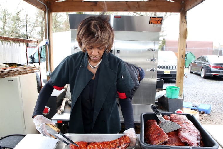 Ruthie Henri, owner and chef, prepares ribs from the smoker at Henri's Hotts Barbeque, in Hammonton, Friday, Feb. 25, 2022. VERNON OGRODNEK / For The Inquirer