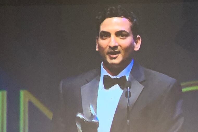 Jonathan Brassington, larger than life at the Kimmel Center, accepts PACT's award for selling his company, LiquidHub, to France-based Capgemini for $500 million. Brassington is now a managing director at Capgemini.