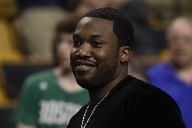 Rapper Meek Mill smiles before the Sixers play the Boston Celtics in game two of the Eastern Conference semifinals on Thursday, May 3, 2018 in Boston.