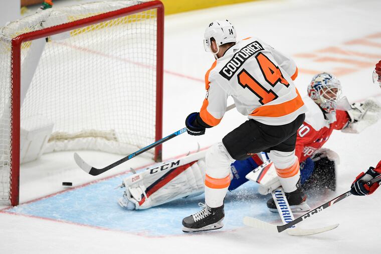 Flyers center Sean Couturier scores a goal past Capitals goaltender Braden Holtby on Saturday.